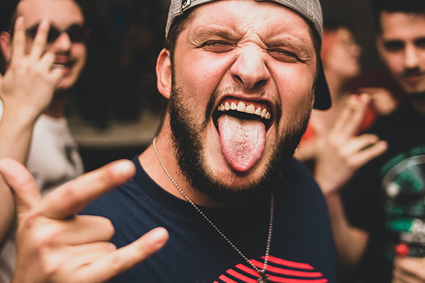 man sticking out his tongue at bachelor Party